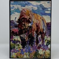 A SMALL JOURNAL - BISON IN WILDFLOWERS in a field of flowers.
