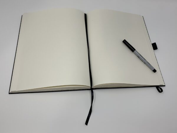 A LARGE JOURNAL - SHIELD with a pen on top.