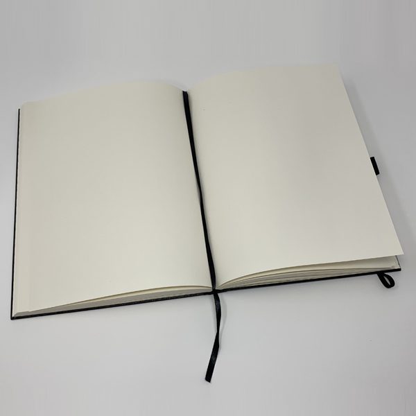 A SMALL JOURNAL - STROLLIN' with a black cover on a white surface.