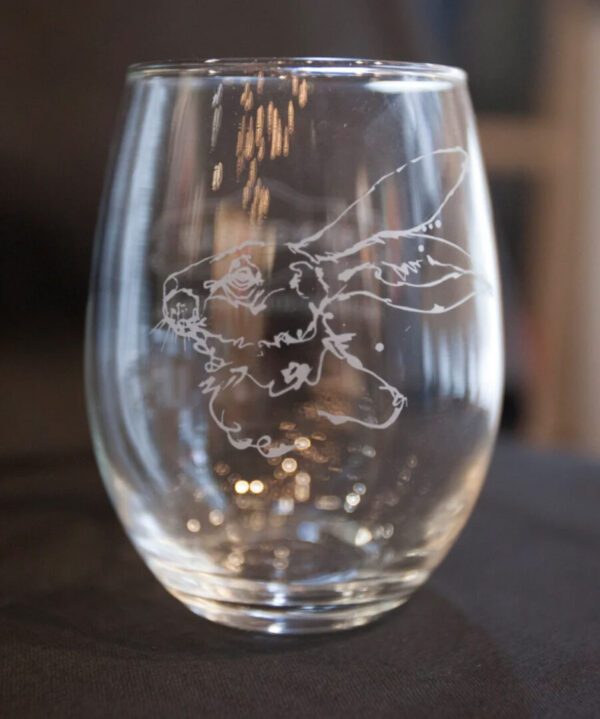 An ETCHED STEMLESS WINE GLASS SET with a drawing of a rabbit on it.