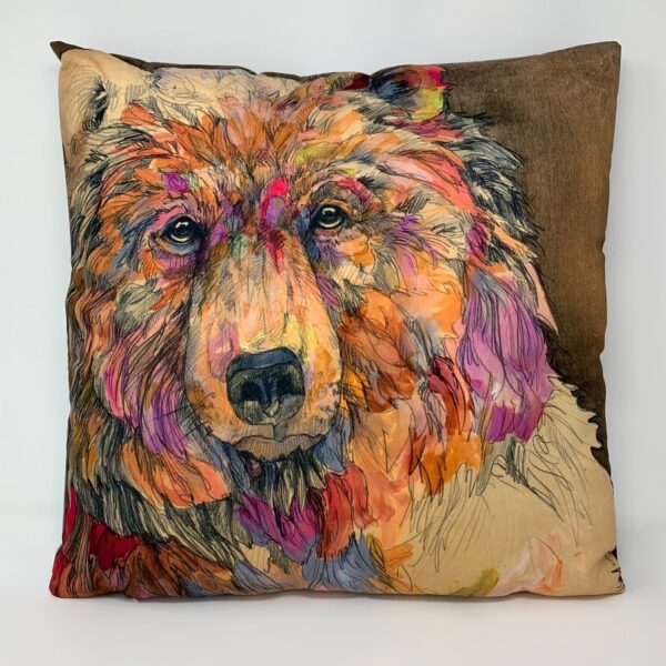 A colorful LARGE PILLOW - BEAR/MOOSE with a bear on it.