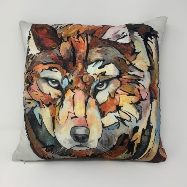 A small pillow with a painting of a wolf on it.