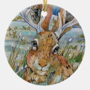 A painting of a hare with antlers christmas ornament.