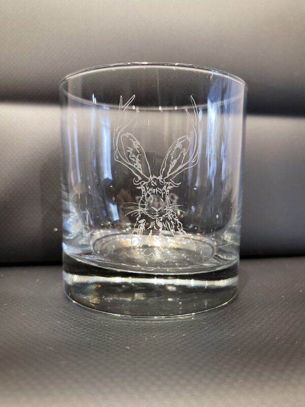 A NEW! - ROCKS GLASS SET with an image of a deer on it.