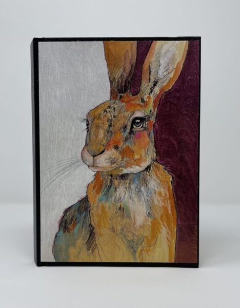 A SMALL JOURNAL - FRESH START with a painting of a hare on a black background.