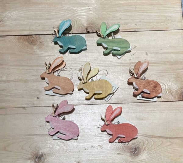 A set of JACKALOPE ORNAMENT - 2022 on a wooden table.