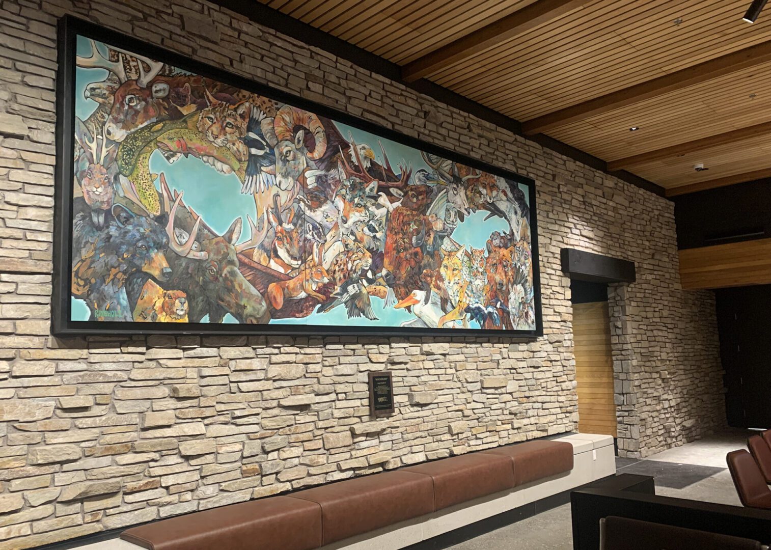 A large painting hangs on the wall of a waiting room.