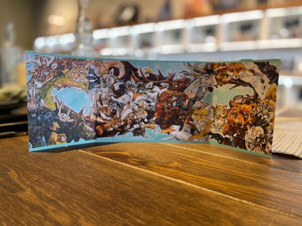 A BOUNDLESS GATE CARD with illustrations on it sitting on a table.