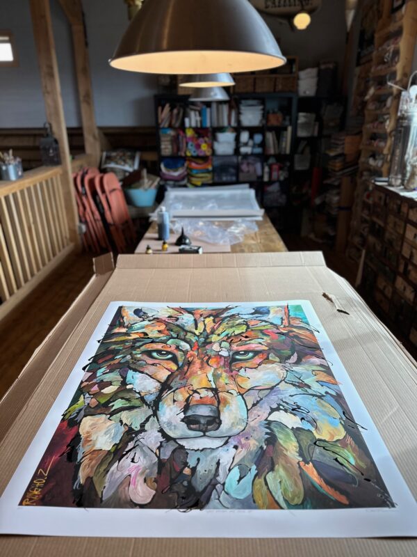 A "Song On The Wind" Limited Edition Print of a wolf sitting on top of a box.