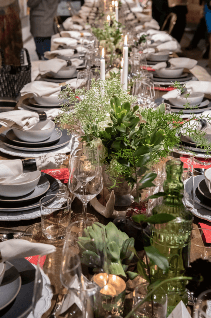 A long table set with plates and silverware.