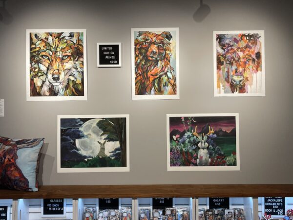 A display of "Emergence" Limited Edition Print on the wall of a store.