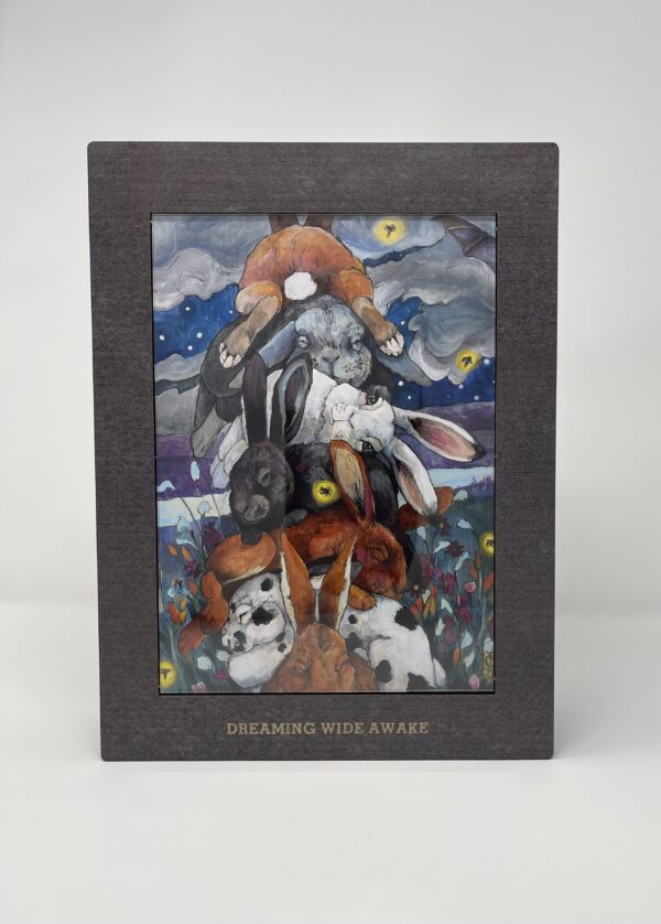A black frame with a 250 PIECE WOODEN PUZZLE - "Dreaming Wide Awake" of a dog and a cat.